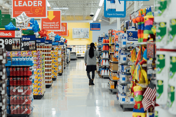 A women who is walking down a store aisle