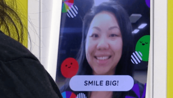 Users smiling at the Smile Sampler prototype to get a sample